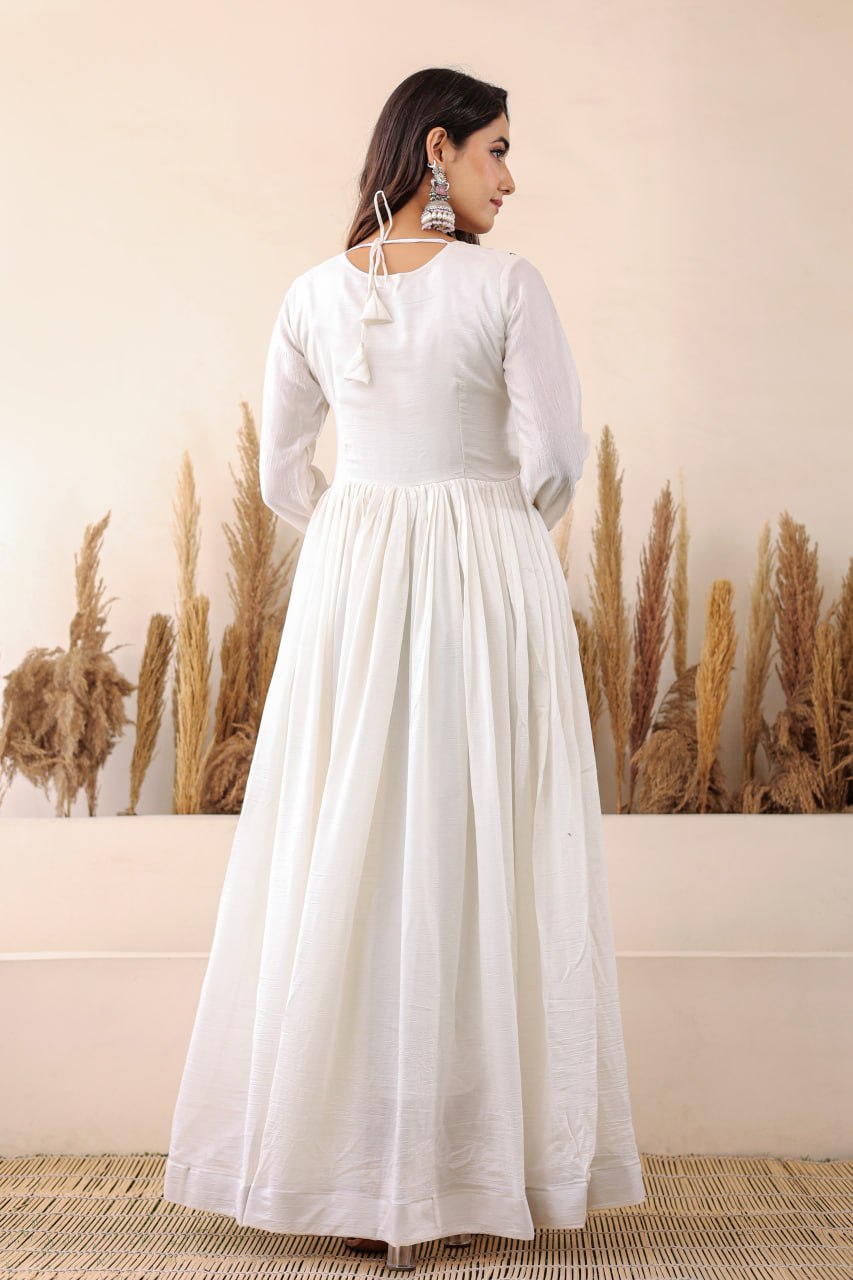 Elegant white Anarkali with floral embroidery, paired with a vibrant floral dupatta. Graceful, festive, and perfect for any celebration.
