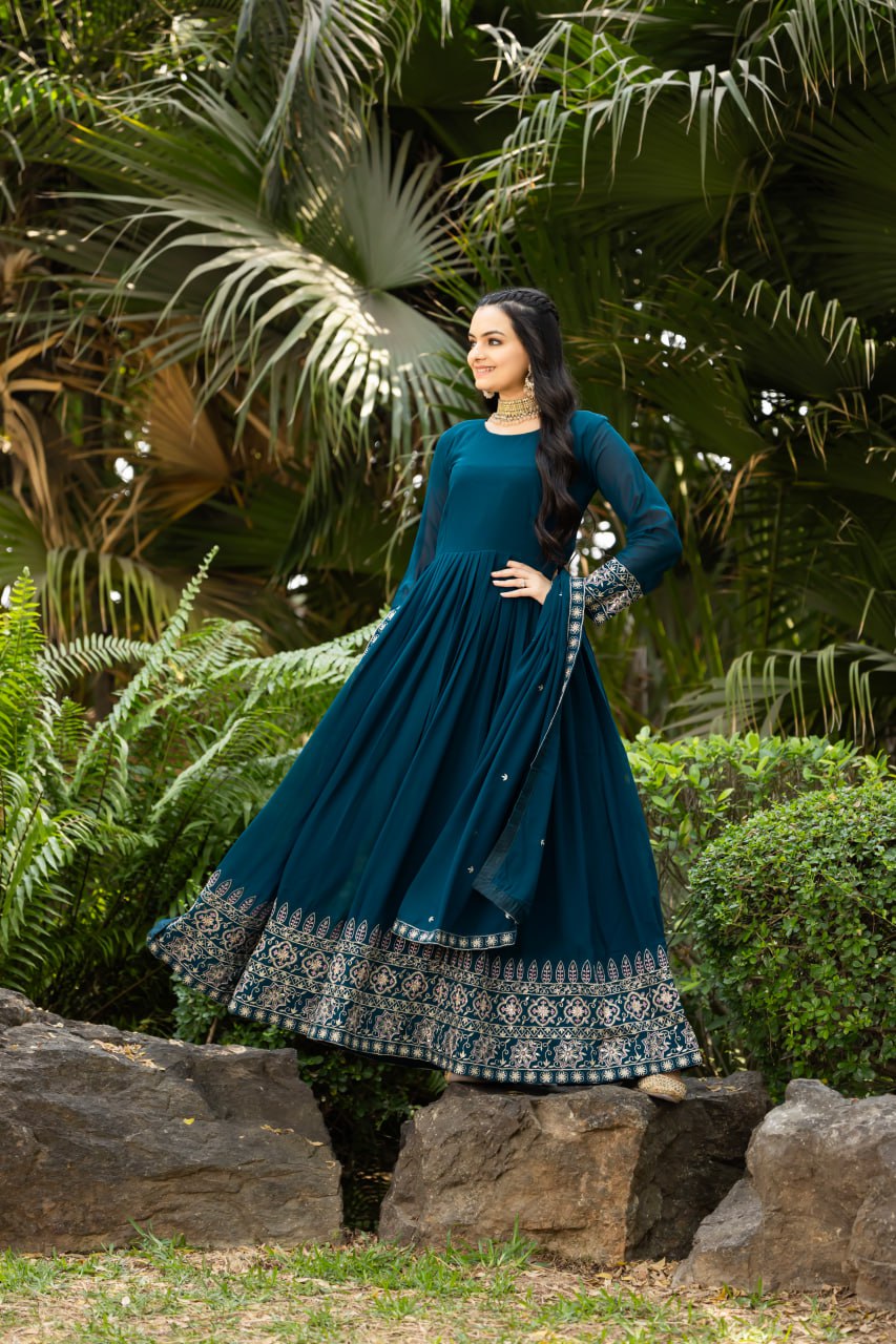 Step into timeless elegance with this stunning floor-length Anarkali gown in a deep teal blue shade.