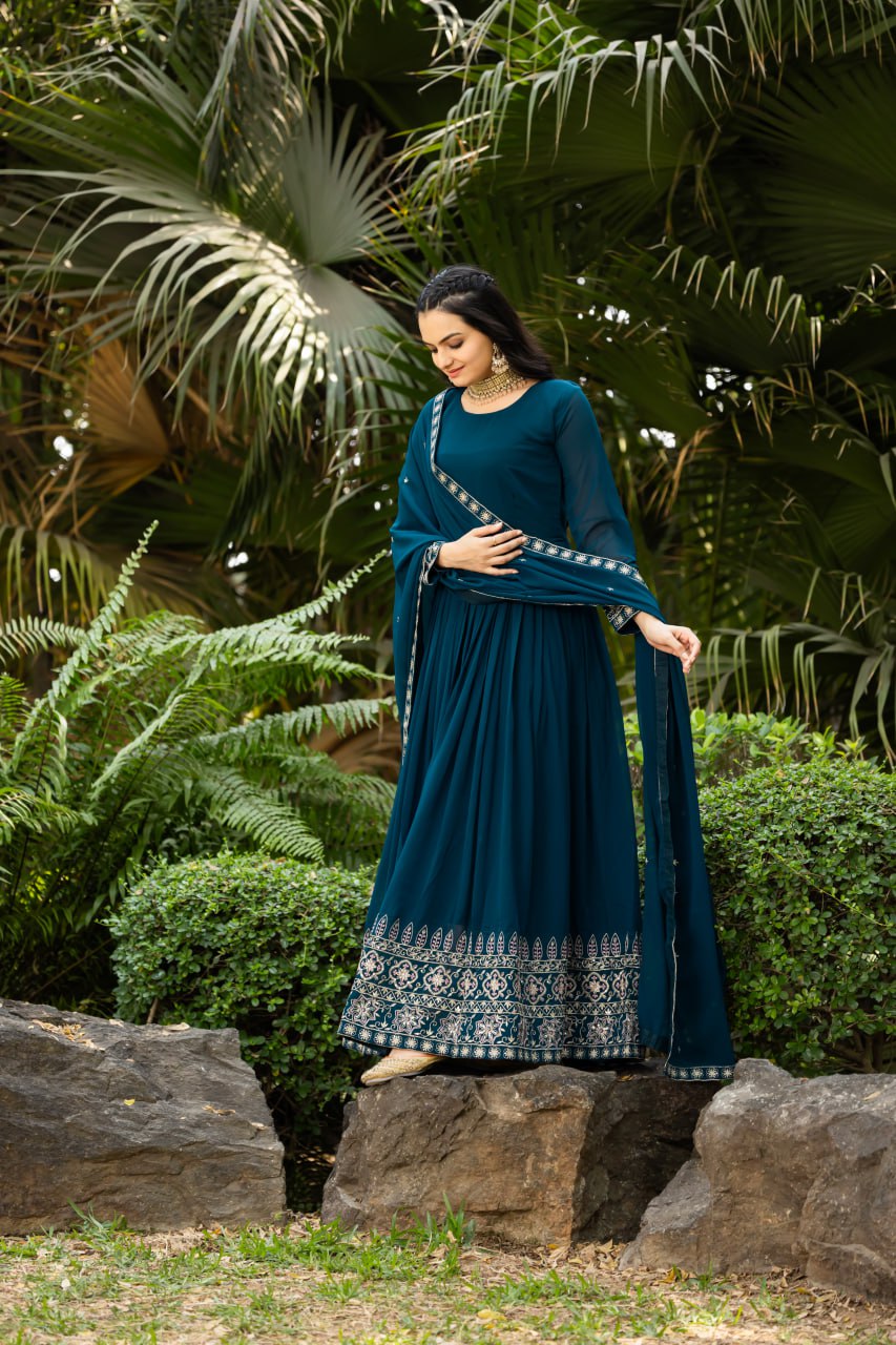 Step into timeless elegance with this stunning floor-length Anarkali gown in a deep teal blue shade.
