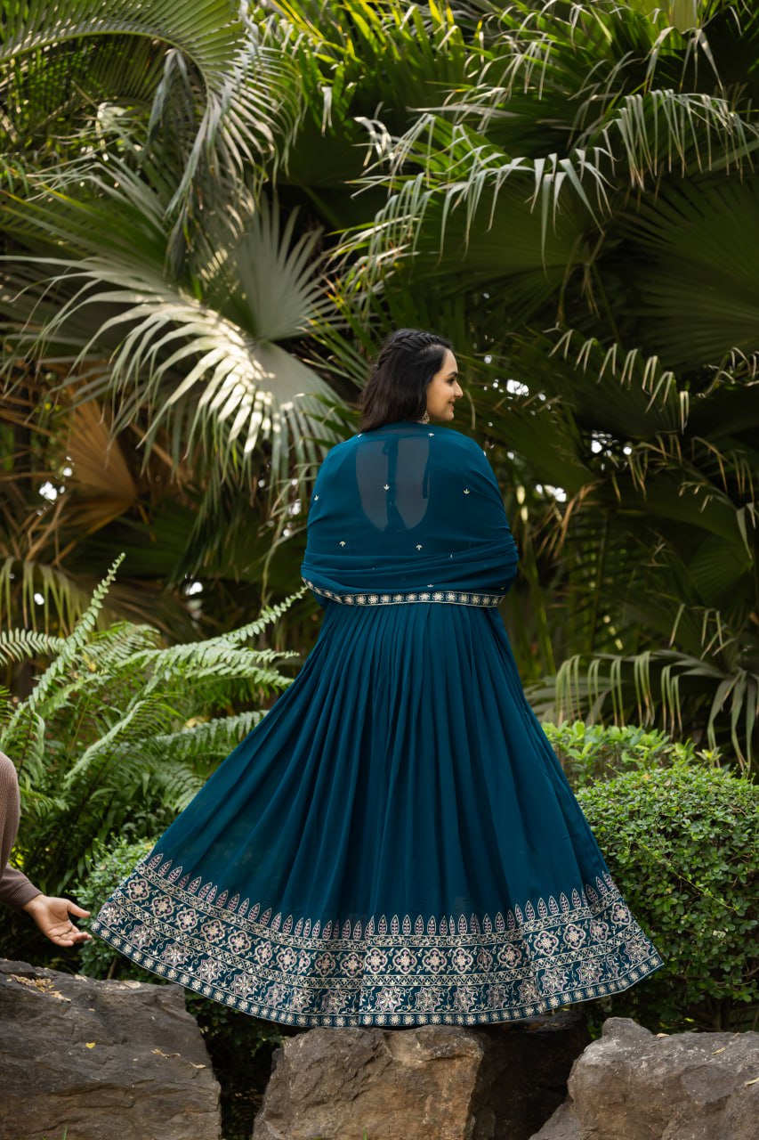 Step into timeless elegance with this stunning floor-length Anarkali gown in a deep teal blue shade.
